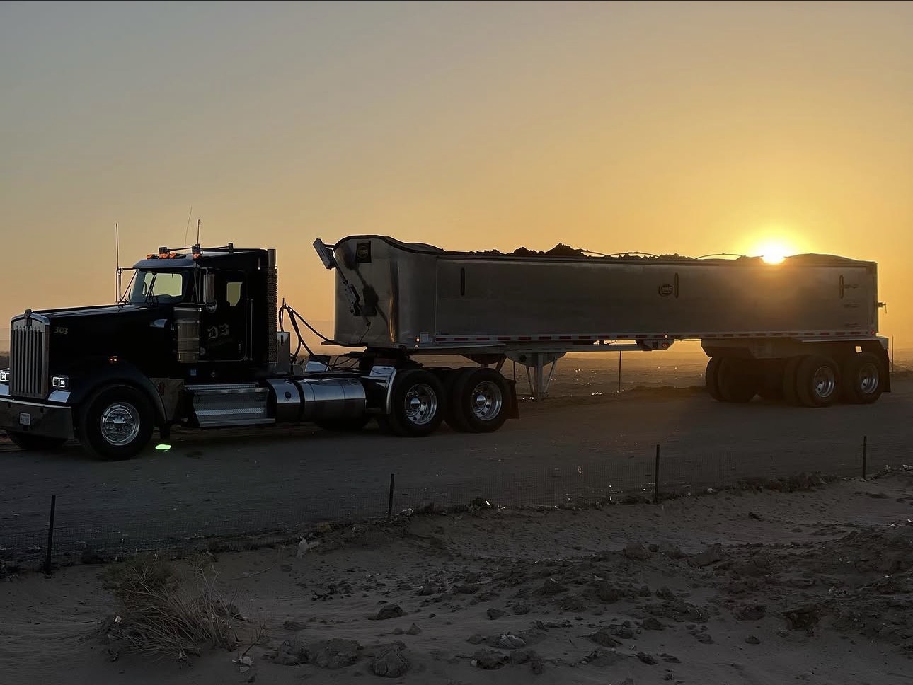 D3 dump truck at sunset